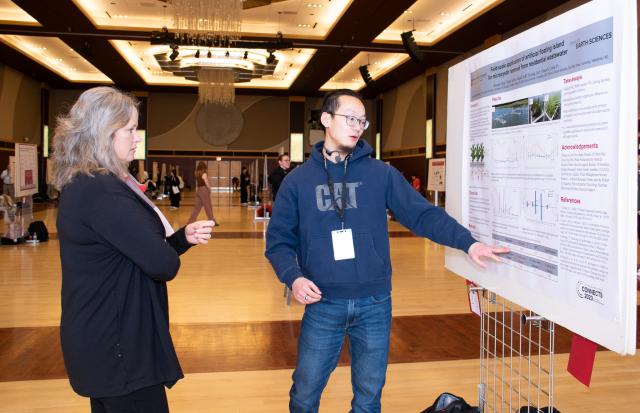 Mary Stromberger, Graduate Dean and graduate student with research poster